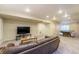 Spacious finished basement with a ping pong table, television, and comfortable seating area at 2204 Lasalle St, Superior, CO 80027