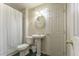 Cozy bathroom featuring a pedestal sink, white fixtures, and a shower with a patterned curtain at 2204 Lasalle St, Superior, CO 80027