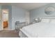 Bright bedroom with a white comforter, desk, and a round mirror over the bed at 2204 Lasalle St, Superior, CO 80027