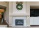 Living room fireplace with white marble tile and large mantle at 2204 Lasalle St, Superior, CO 80027