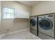 Spacious laundry room with side-by-side washer and dryer, and storage cabinets at 2204 Lasalle St, Superior, CO 80027