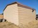 Large metal garage with brown trim at 6255 Wolf Creek Rd, Strasburg, CO 80136