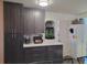 Modern kitchen with dark cabinets and white countertops at 6255 Wolf Creek Rd, Strasburg, CO 80136