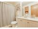 Bathroom featuring vanity with storage, toilet, shower curtain and neutral decor at 7040 Routt St, Arvada, CO 80004