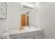 Bathroom featuring vanity with storage, good lighting and neutral decor at 7040 Routt St, Arvada, CO 80004