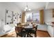 Bright dining area featuring a round table, ample natural light, and built-in shelves at 7040 Routt St, Arvada, CO 80004