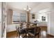 Charming dining area with a round table, chandelier, and built-in shelving at 7040 Routt St, Arvada, CO 80004