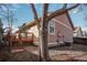 Backyard with a mature tree and exterior of the home at 7040 Routt St, Arvada, CO 80004