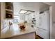 Bright kitchen with white cabinets, plenty of countertop space, and modern appliances at 7040 Routt St, Arvada, CO 80004