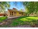 Home's backyard showcasing its lawn, patio, and mature landscaping at 7548 S Crocker Ct, Littleton, CO 80120