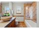 Bathroom featuring a stone vessel sink, updated tiling and a shower with a built-in bench at 7548 S Crocker Ct, Littleton, CO 80120