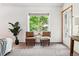 Bedroom featuring a relaxing seating area with a view of the outdoors and a convenient door to the outside at 7548 S Crocker Ct, Littleton, CO 80120