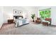 Bright bedroom featuring a comfy bed, side tables with lamps, and a cozy sitting area by the window at 7548 S Crocker Ct, Littleton, CO 80120