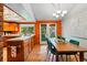 Bright dining area featuring a table with chairs, wooden cabinets, and natural light streaming through large windows at 7548 S Crocker Ct, Littleton, CO 80120