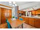 Warm and inviting dining area with a table and chairs, complemented by wooden cabinets and abundant natural light at 7548 S Crocker Ct, Littleton, CO 80120