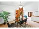 Dining room with brick accent wall, glass table and view to kitchen and living room at 7548 S Crocker Ct, Littleton, CO 80120