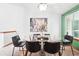 A dining room with a glass table, modern chairs, and a large city print at 7548 S Crocker Ct, Littleton, CO 80120