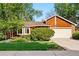 Charming single-Gathering home featuring a manicured lawn, mature trees, and a two-car garage, perfect for suburban living at 7548 S Crocker Ct, Littleton, CO 80120