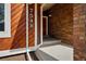 Inviting front porch showcasing a brick accent wall and wooden siding, adding character to the home's entrance at 7548 S Crocker Ct, Littleton, CO 80120