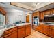 A warm kitchen with brick and wood accents, stainless steel appliances and view into the dining room at 7548 S Crocker Ct, Littleton, CO 80120