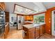 Traditional kitchen featuring stainless steel appliances, terracotta tile floors, and tile countertops at 7548 S Crocker Ct, Littleton, CO 80120