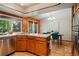 Bright eat-in kitchen featuring stainless appliances, wooden cabinets, and a tile counter with a view to the backyard at 7548 S Crocker Ct, Littleton, CO 80120