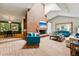 Cozy living room with high ceilings, brick fireplace and hearth, perfect for gathering and entertaining at 7548 S Crocker Ct, Littleton, CO 80120