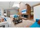 Open-concept living room showcasing a striking brick fireplace, vaulted ceilings, and ample seating at 7548 S Crocker Ct, Littleton, CO 80120