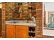 Wet bar with wine storage, sink, and glass shelving at 7548 S Crocker Ct, Littleton, CO 80120