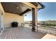 Covered balcony with brown deck, black railing, and stone supports perfect for outdoor enjoyment at 365 Casalon Pl, Superior, CO 80027