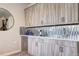 Chic bar area featuring elegant cabinetry, a mirrored backsplash, and a stylish countertop for sophisticated entertaining at 365 Casalon Pl, Superior, CO 80027