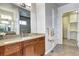 Bathroom vanity with wood cabinets, granite countertops, undermount sink, and a mirror at 365 Casalon Pl, Superior, CO 80027