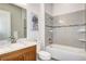 Bathroom features a vanity with a wood cabinet, granite countertop, and a tub-shower combo at 365 Casalon Pl, Superior, CO 80027