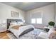 Bedroom features a gray upholstered bed, side tables, window, soft rug, and chairs at 365 Casalon Pl, Superior, CO 80027