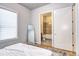 Bedroom with a doorway to a bathroom, offering a glimpse of the tiled shower and bathtub at 365 Casalon Pl, Superior, CO 80027
