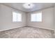 Bright and airy bedroom featuring neutral walls, plush carpeting, and two windows offering ample natural light at 365 Casalon Pl, Superior, CO 80027