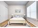 Bright bedroom features a soft bed, modern side tables, art, light wood floor and a large window at 365 Casalon Pl, Superior, CO 80027