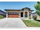 Charming single-story home with a two-car garage, stone accents, and a well-manicured lawn at 365 Casalon Pl, Superior, CO 80027