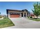 Charming home featuring stone accents, a spacious garage, and a well-manicured lawn at 365 Casalon Pl, Superior, CO 80027