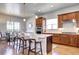 Spacious kitchen with stainless steel appliances, an island with counter seating, and abundant wood cabinets at 365 Casalon Pl, Superior, CO 80027