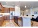 Eat-in kitchen features an island, stainless steel appliances, and seamless flow into the living area at 365 Casalon Pl, Superior, CO 80027