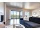 Bright living room with a fireplace, comfortable seating, and access to a balcony with a view at 365 Casalon Pl, Superior, CO 80027
