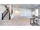 Bright living room with staircase, plush carpeting, and ample space for seating, perfect for relaxation and gatherings at 365 Casalon Pl, Superior, CO 80027