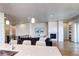 Open concept living space featuring a fireplace, plush seating, and a seamless flow to the balcony at 365 Casalon Pl, Superior, CO 80027