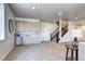 Stylish living room featuring a bar, staircase, and soft carpeting, providing a seamless blend of comfort and sophistication at 365 Casalon Pl, Superior, CO 80027