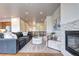 Inviting living room with a fireplace, comfortable seating, and seamless access to other living areas at 365 Casalon Pl, Superior, CO 80027