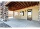 Covered patio features stone accents, a stained concrete floor, and a glass door to the backyard at 365 Casalon Pl, Superior, CO 80027