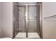 Elegant shower with grey tiling, glass enclosure, and dual shower heads providing a luxurious and modern bathing experience at 365 Casalon Pl, Superior, CO 80027
