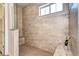 Large tiled shower with a bench and glass enclosure; neutral color palette and natural light at 365 Casalon Pl, Superior, CO 80027