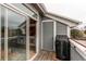 Balcony with wood floors features a grill, door to storage, and sliding glass doors at 8500 E Jefferson Ave # 7B, Denver, CO 80237